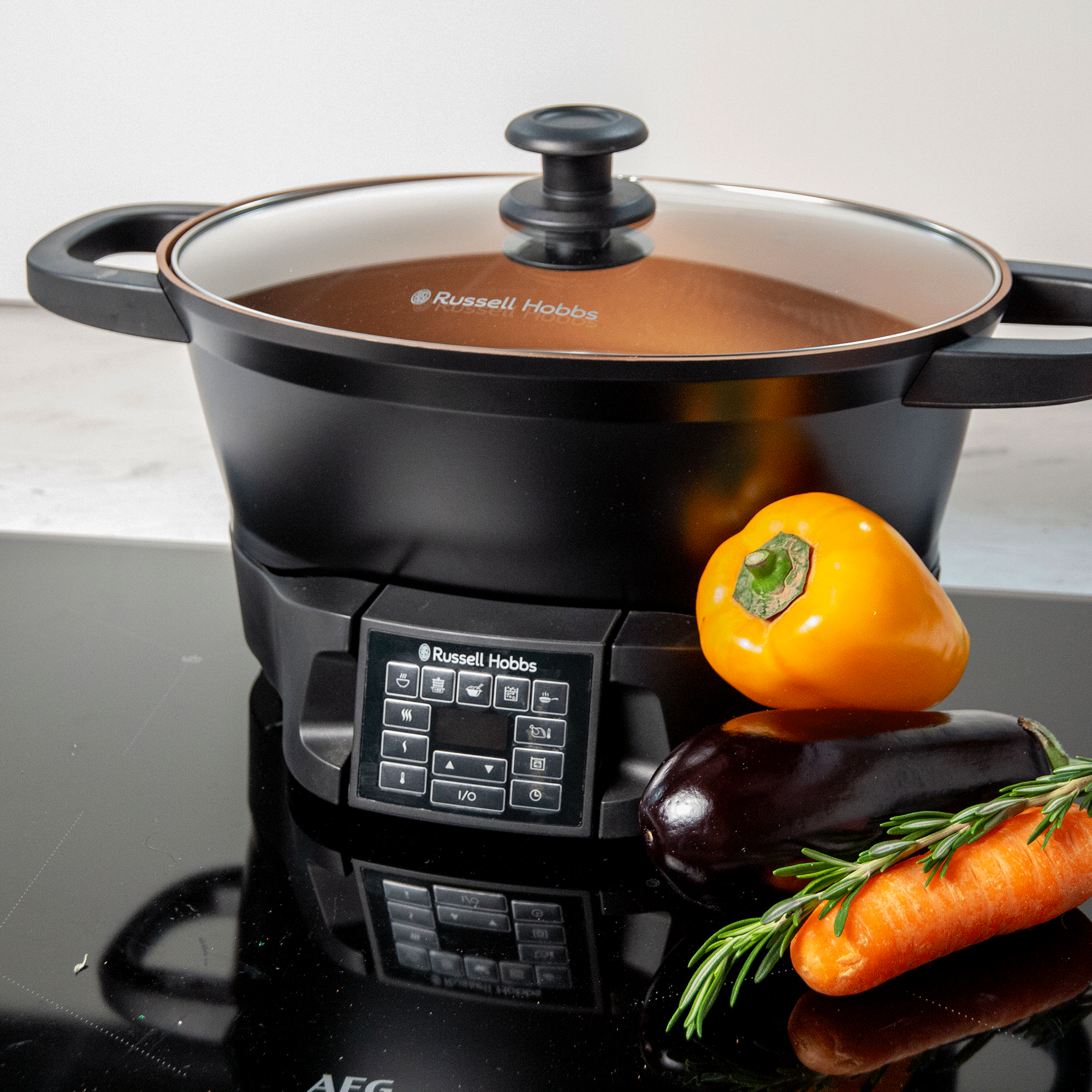 Black slow cooker on a hob