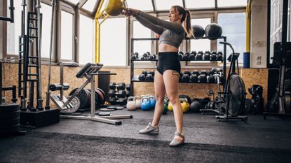 Woman performing kettlebell swings