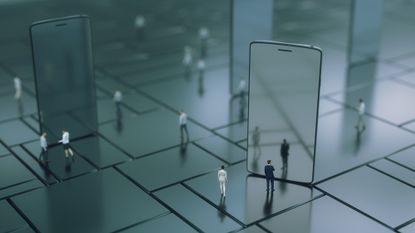 Miniature people around an iPhone