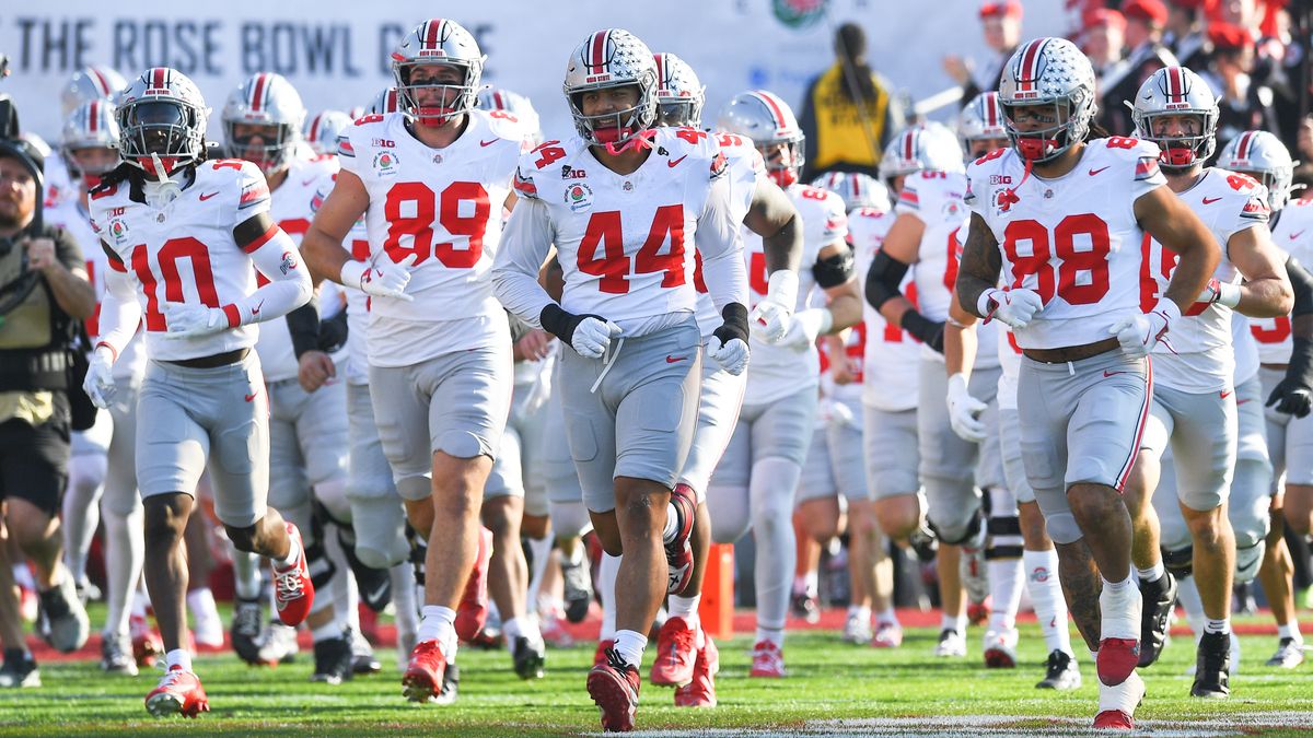 Ohio State players run onto the field the College Football Playoffs quarter-final