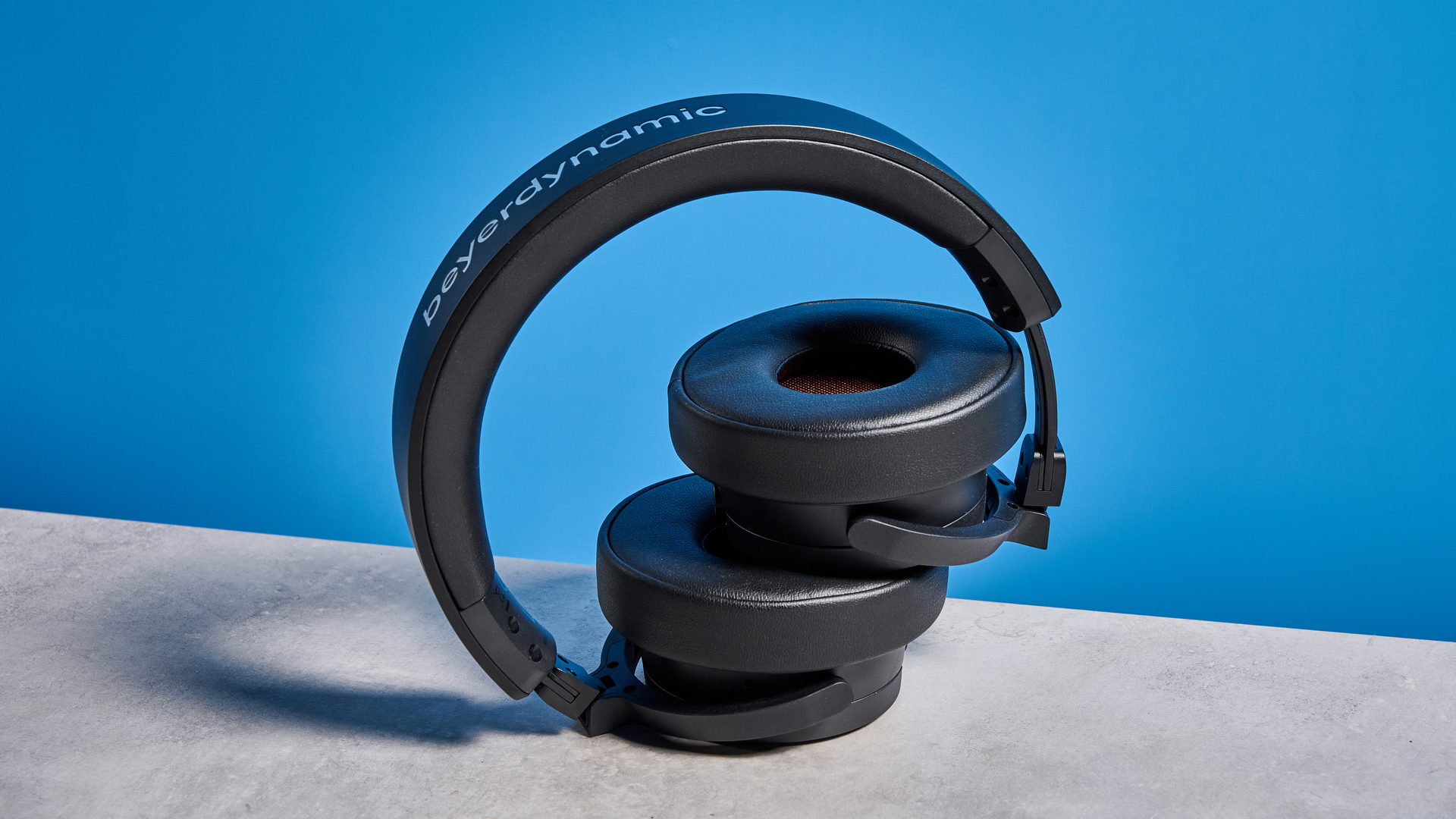 the beyerdynamic DJ 300 Pro X headphones in black showing their ear cups, carry bag, and connectivity options photographed against the blue tom's guide background