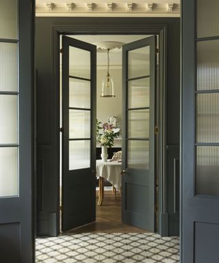 Glass fronted display cabinet covered with reeded window film in a living room