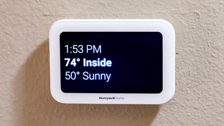 Honeywell Home X8S Smart Thermostat mounted to a hallway wall