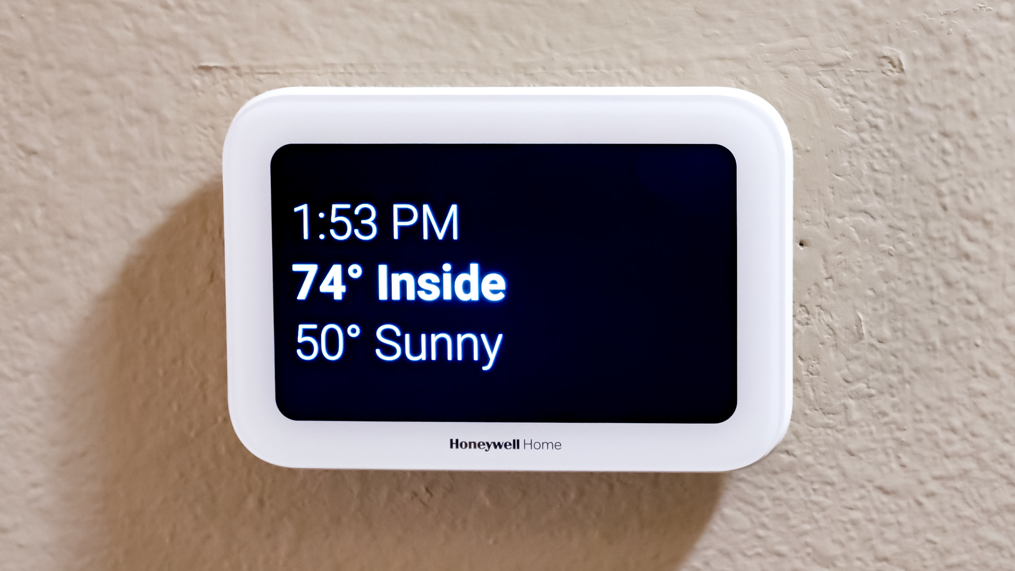 Honeywell Home X8S Smart Thermostat mounted to a hallway wall