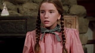 Melissa Gilbert in pigtails, wearing a pink dress as Laura Ingalls in Little House On The Prairie