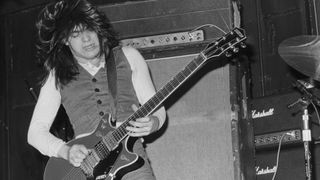 Malcolm Young performing with hard rock group AC/DC at the Marquee Club, London, 12th May 1976.