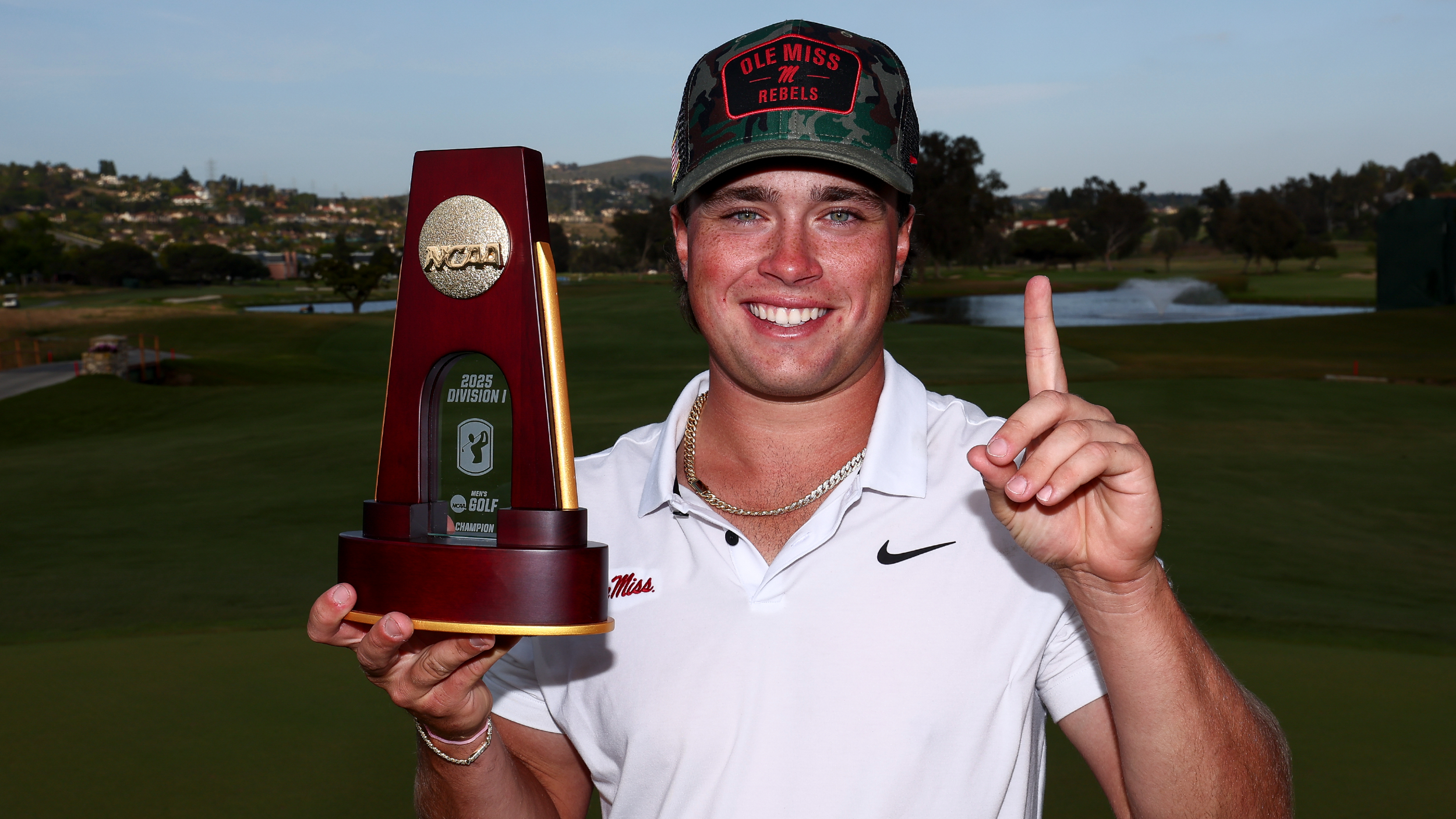 Michael La Sasso with the NCAA Division I Men's Golf Championship trophy