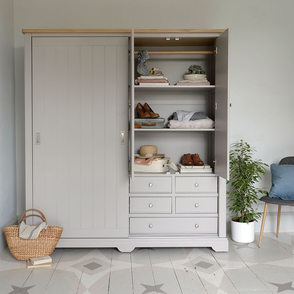 Grey wardrobe on star pattern floor next to pot plant