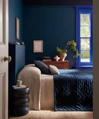 Regal looking bedroom with walls in Royal Navy™, ceiling and above chair rail in Dock Blue™and window frame in Smalt