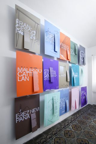 A wall filled with posters displaying the words of Maria Cristina Didero