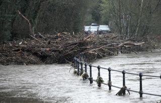 Debris lays across Ford Lane in Northenden as water levels of the River Mersey begin to recede after Storm Franklin on February 21, 2022 .