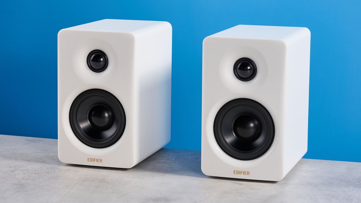 the edifier m60 bookshelf speakers in white photographed against the blue tom's guide background