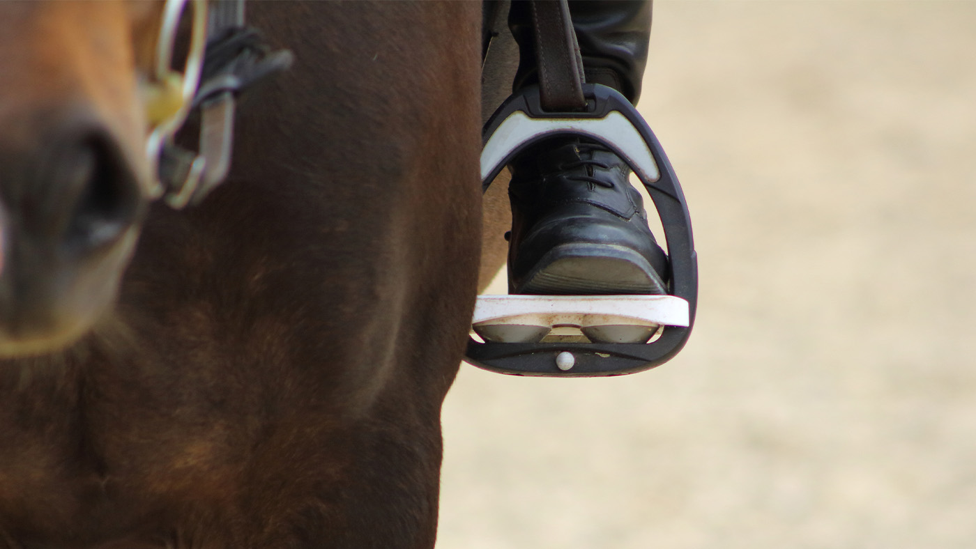 Close up of horse rider&amp;rsquo;s foot in stirrup