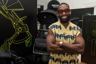 Tinie Tempah with his Rise Stroller from the Rise by Tinie range of car seat, pushchair and travel cot
