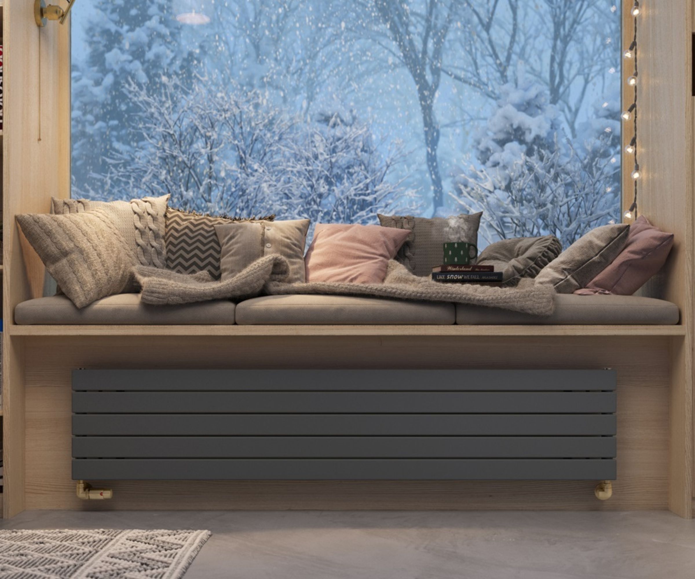 A cosy built-in window seat styled with layered cushions and a knitted throw, with a sleek grey radiator neatly integrated beneath.