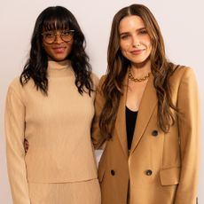 Nia Batts and Sophia Bush side by side in front of a step and repeat at the Marie Claire power play event