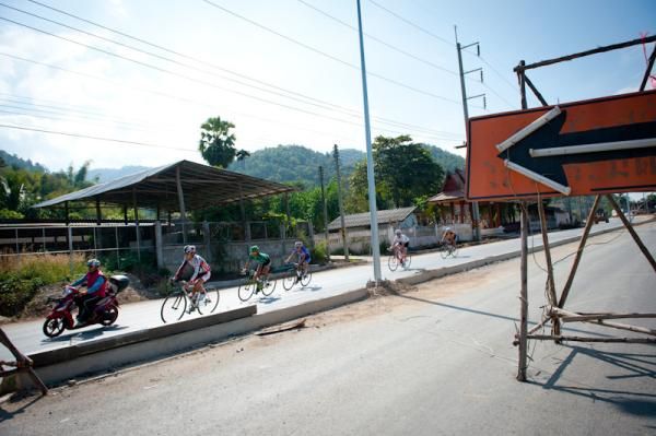 Riders pass the under construction road