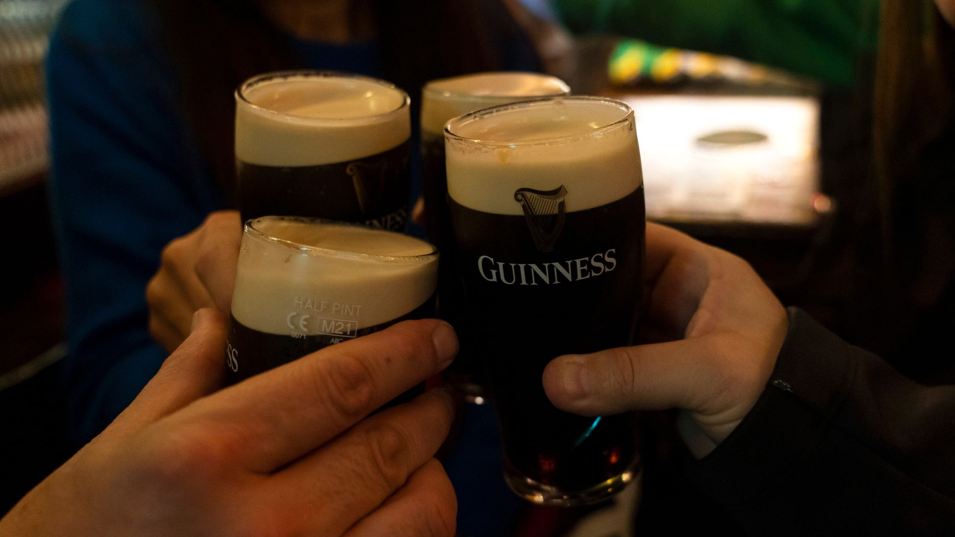 Dublin Daily LifeYoung people toasting inside a pub with half pints of Guinness black beer (Photo by Joaquin Gomez Sastre/NurPhoto via Getty Images)