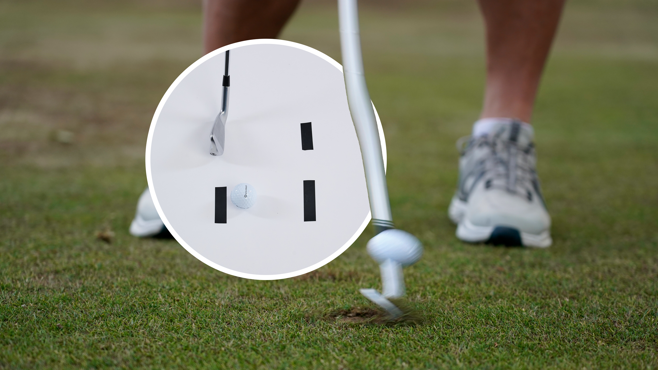 A ball being struck at impact, with the divot starting to be taken as the ball flies off the face, with an inset image of the sticky tape drill that can help high-handicappers with ball striking