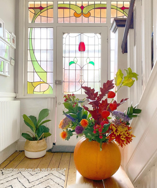 DIY pumpkin idea in hallway with stair glass window detail