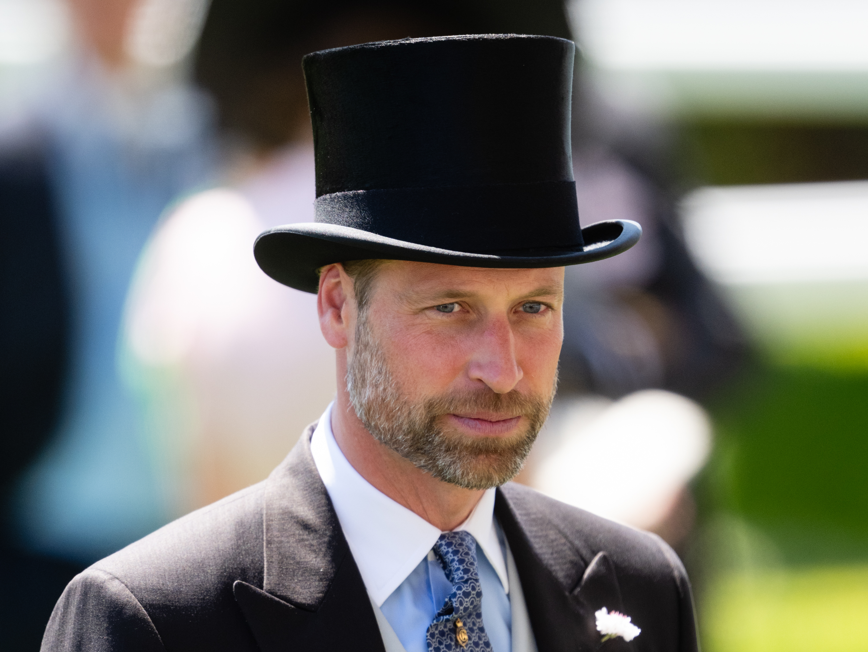 Prince William wearing a black top hat and suit