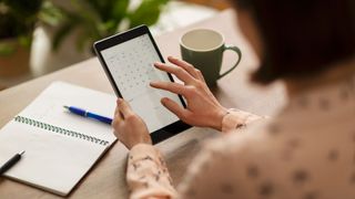 Woman looking at calendar on tablet