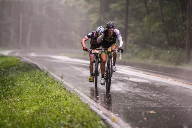 The sunshine was quickly wiped out by a fast-moving midday storm that drenched the course, hitting the leaders as they headed away from the Dowell Draft descent. Kevin Carter (Gripped Racing), front, adjusts his glasses to help keep his eyes on the road.