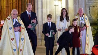Princess Charlotte has her candle blown out by Prince Louis at the "Together At Christmas" Carol Service"