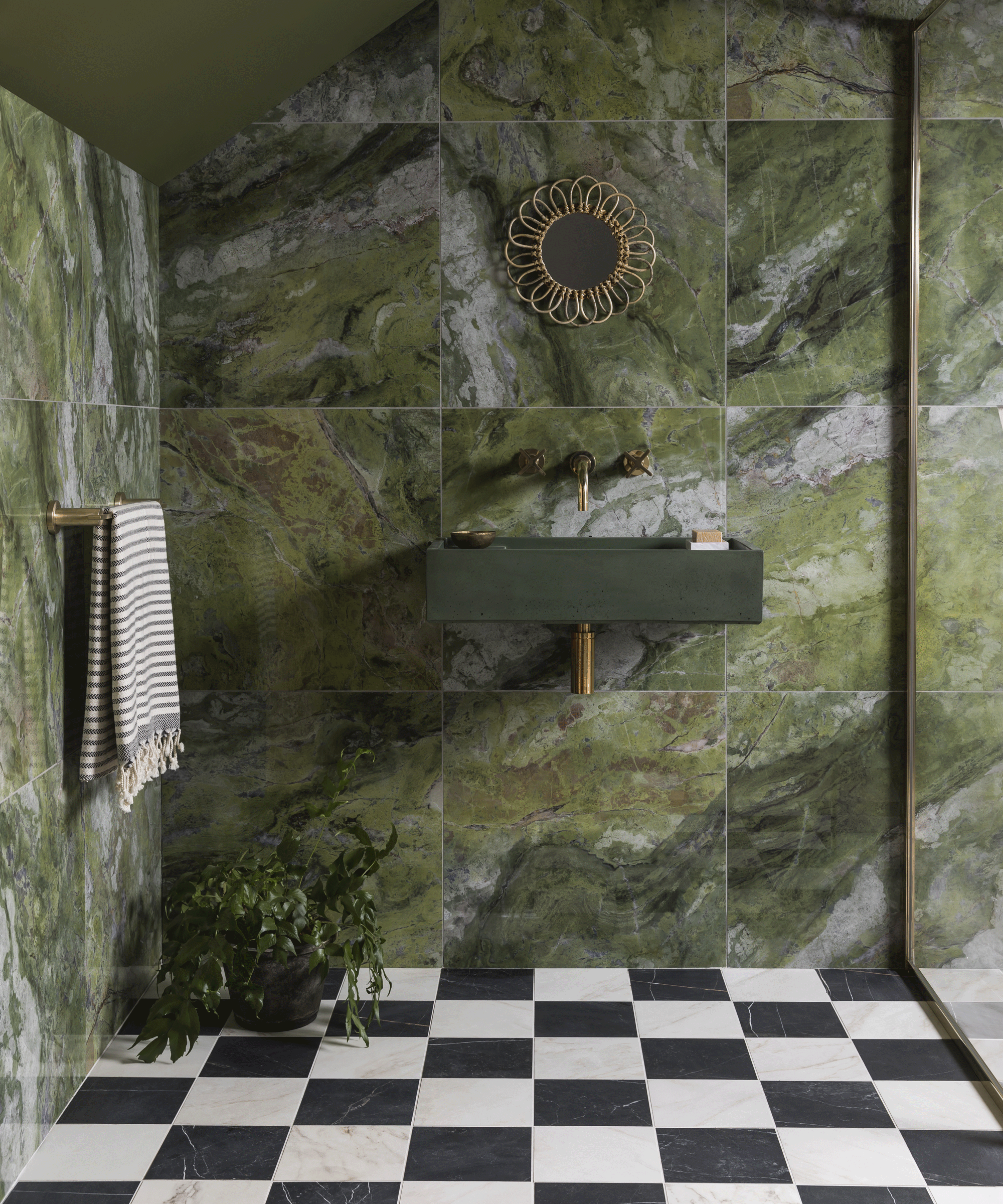 Shower with green marble tiles and black and white checkered floor
