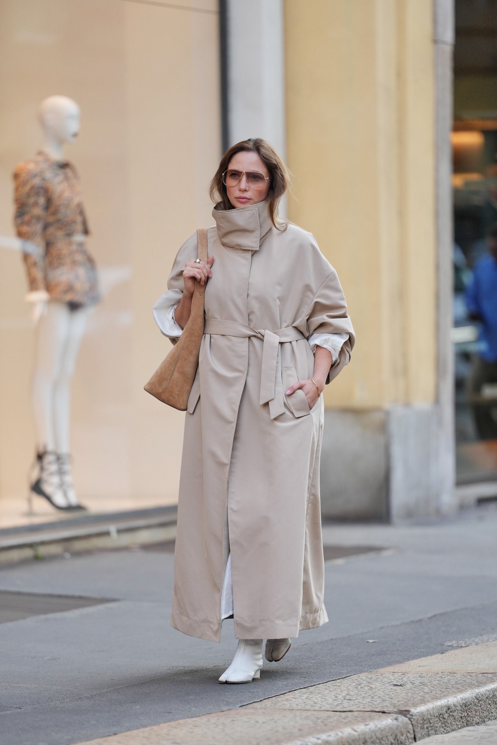 street style woman wearing funnel neck trench coat in khaki