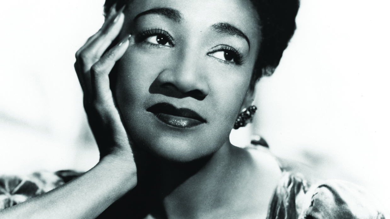 Alberta Hunter gazing to her left, resting her chin on her right hand.