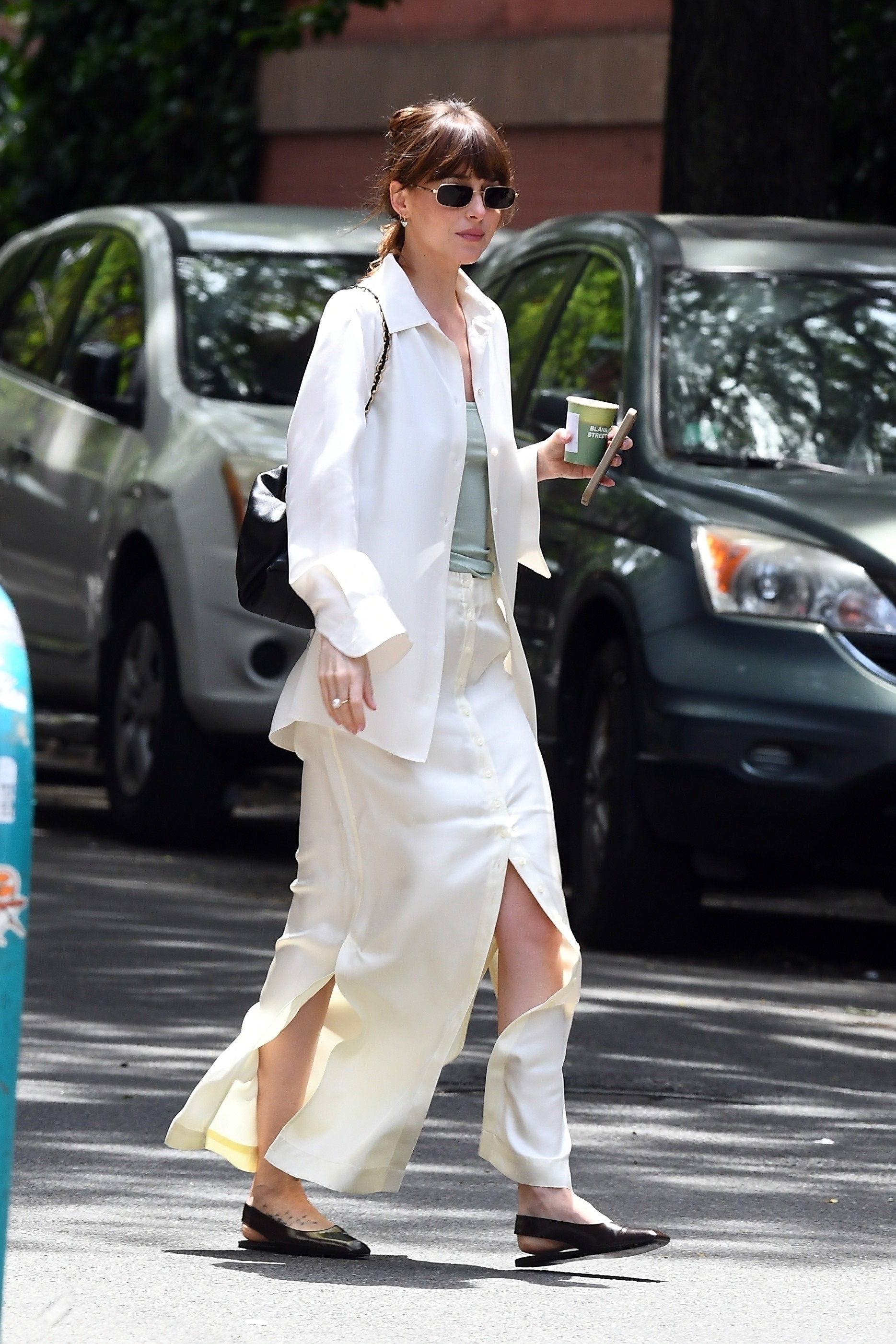 In May 2023, Dakota filmed 'Materialists' in an airy white skirt.