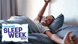 Man smiling and stretching in bed