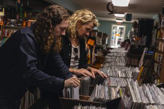 Graham Whitford and Caleb Crosby looking through the racks at Grimey's record store