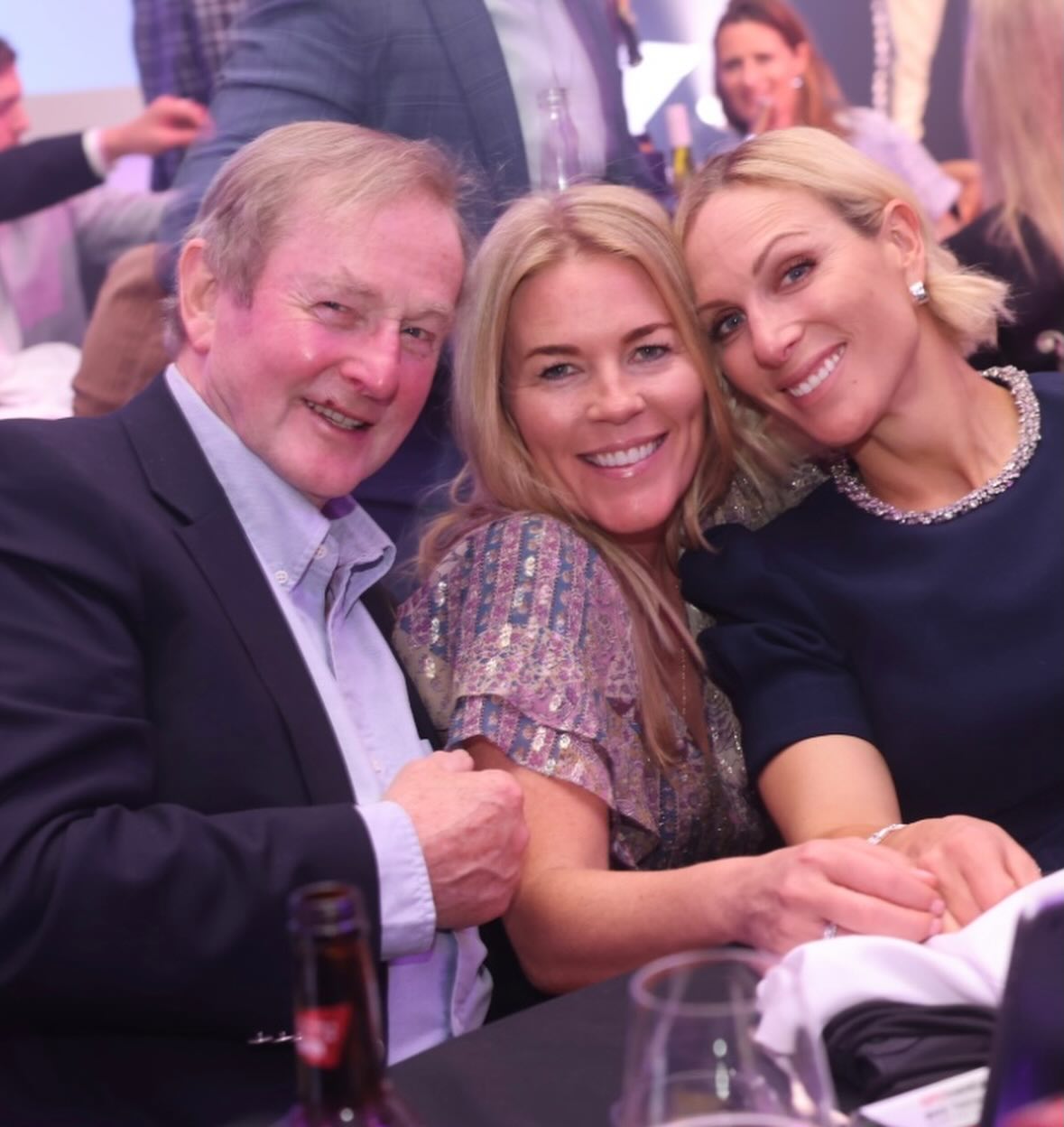 Autumn Kelly and Zara Tindall posing with a man at a table