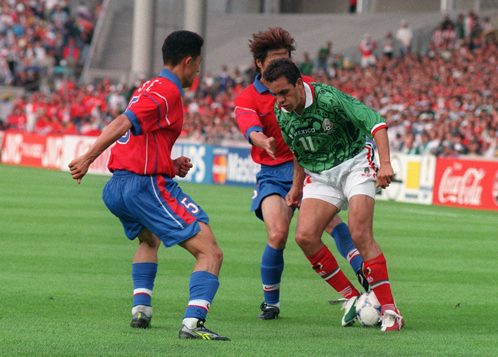 Mexico's Cuauhtemoc Blanco under pressure from two South Korea defenders at the 1998 World Cup.