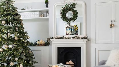 room with fireplace grey sofa and christmas tree