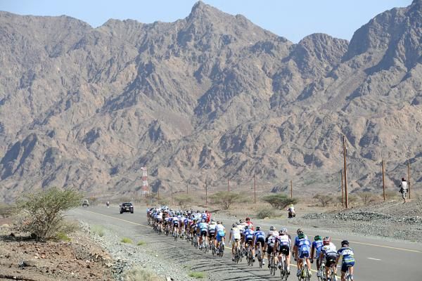 The peloton races into the jagged hills of Oman