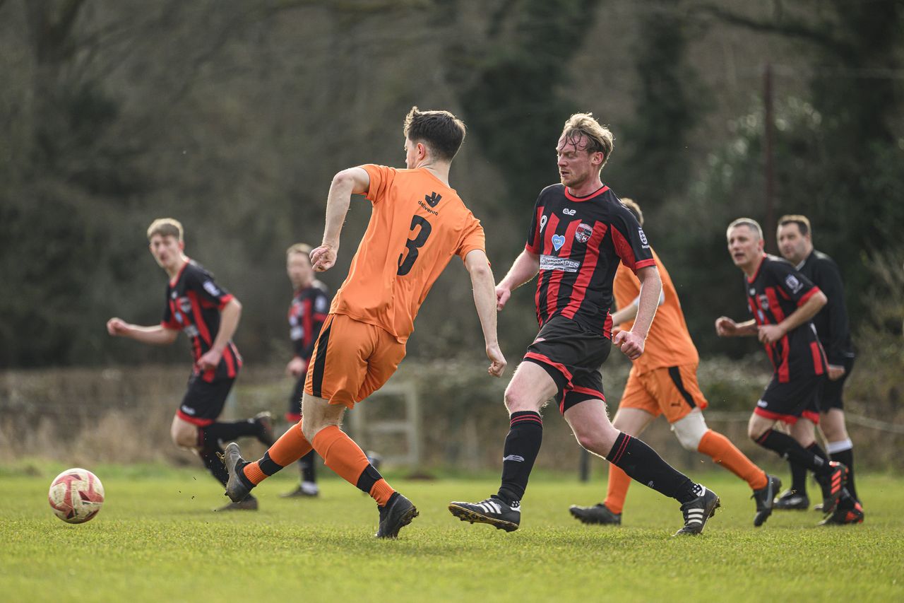 Two footballers playing a match