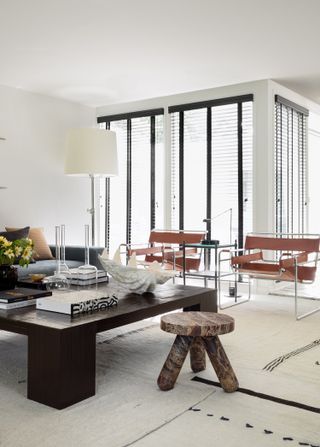 living room with square black coffee table, marble stool, and wassily chairs