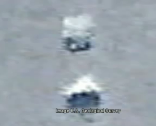 Pixellated objects in Antarctica as seen by Google Earth. They are likely bumps in terrain casting shadows.