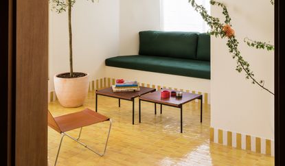 a living room with a yellow tiled floor