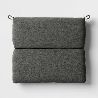 A dark grey outdoor seat cushion