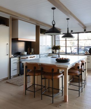 Wood kitchen with an island and traditional range cooker