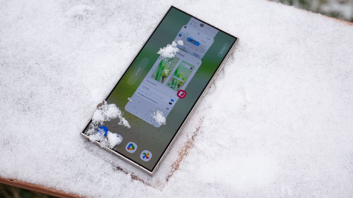 A Samsung Galaxy S24 Ultra with snow on its display