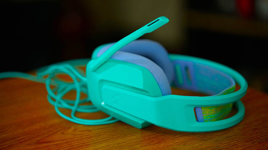 Logitech G335 on a wooden table in front of a bookshelf