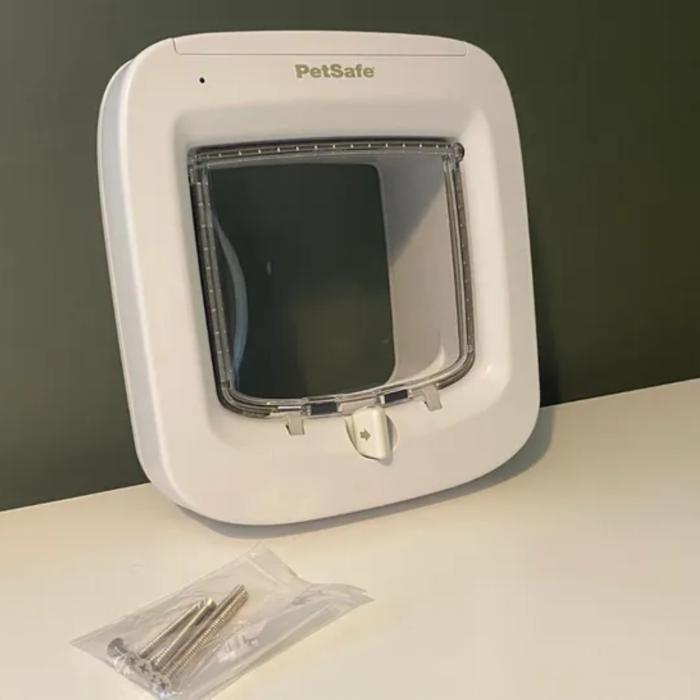 PetSafe 4-Way Locking Microchip Entry Cat Door, one of the best microchip cat flaps, with the screws in a bag