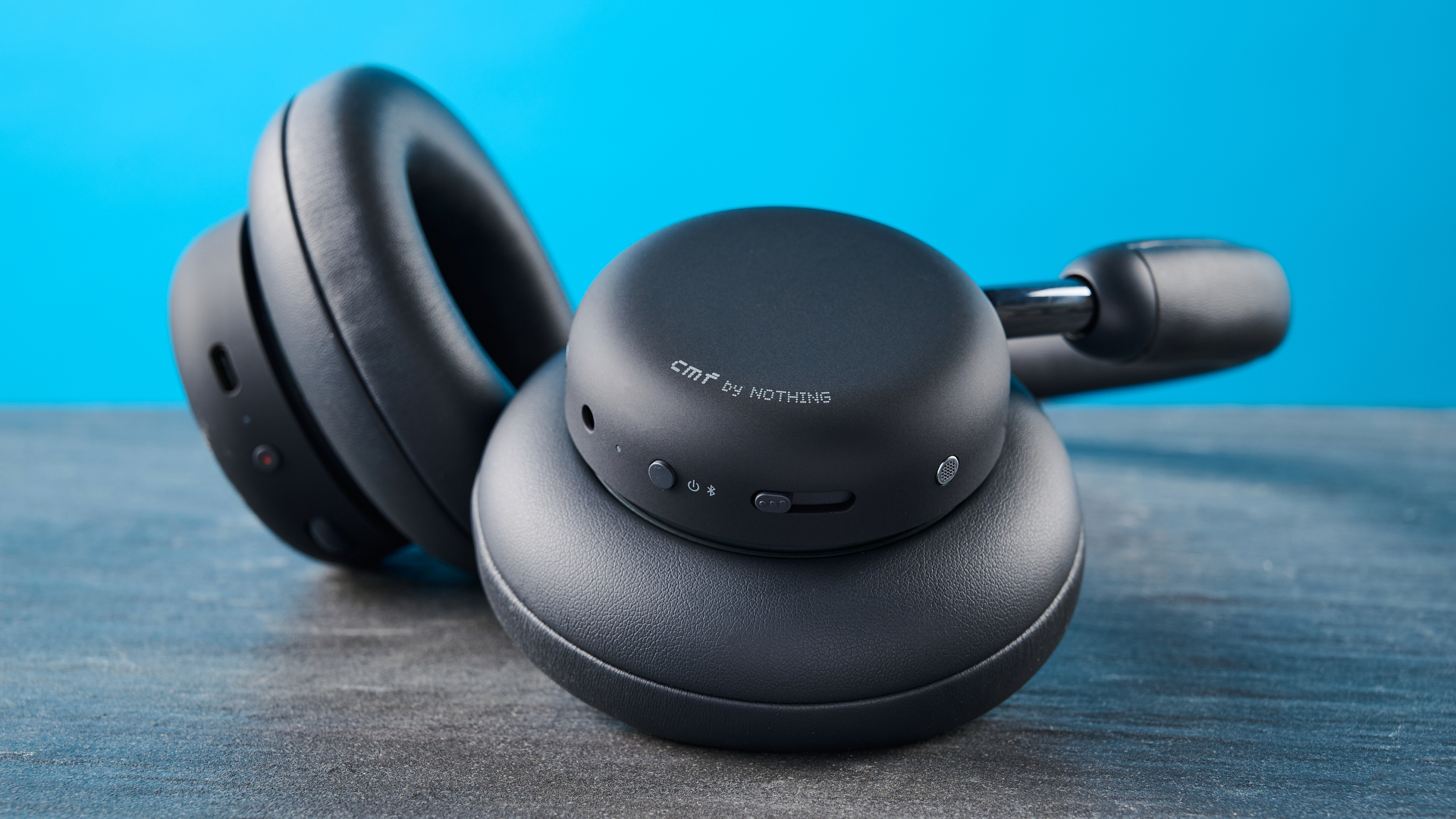 the cmf headphone pro / cmf by nothing headphone pro / nothing headphone pro in black photographed against a blue tom's guide background