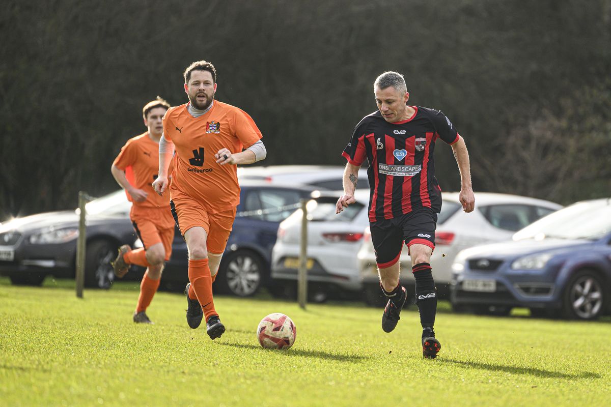 Two footballers playing a match