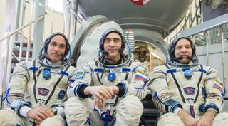 NASA astronaut Chris Cassidy (left) and Russian cosmonauts Anatoly Ivanishin (center) and Ivan Vagner (right) prepare for liftoff. 